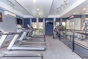 East Lansing townhouse for rent - A home gym with treadmills and exercise equipment.