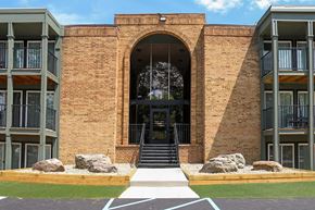 East Lansing townhouse for rent - A building with a large arched entrance and a brick facade.