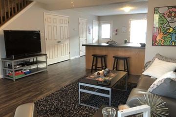 Bloomington apartment for rent - A living room with a black coffee table and a TV on a stand.