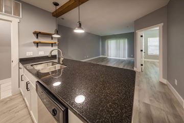 Bloomington apartment for rent - A kitchen with a granite countertop and a sink.