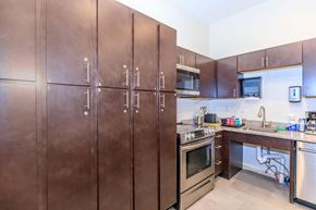 Bloomington apartment for rent - A kitchen with brown cabinets and stainless steel appliances.