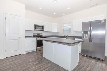 Lafayette apartment for rent - A kitchen with white cabinets and a stainless steel refrigerator.