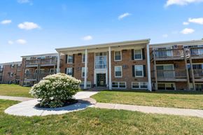 East Lansing apartment for rent - A building with a small bush in front of it.