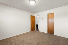 East Lansing apartment for rent - A room with two doors and carpeted floor.