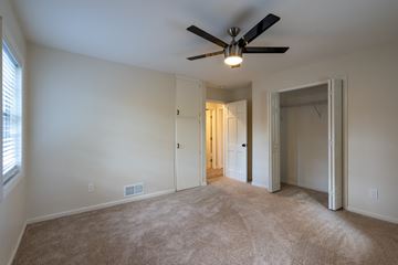 College Park apartment for rent - a living room with carpet and a ceiling fan