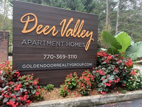 Atlanta apartment for rent - a sign for dees valley apartment homes with flowers around it