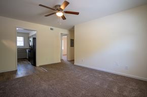 Atlanta apartment for rent - a empty living room with a ceiling fan and carpeting