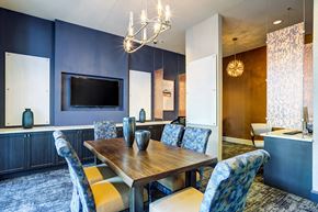 Houston apartment for rent - a dining room with a table and chairs and a television