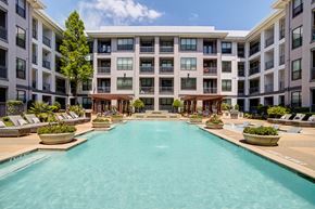 Houston apartment for rent - a swimming pool in front of an apartment building