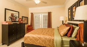 Houston apartment for rent - a bedroom with a bed and a dresser