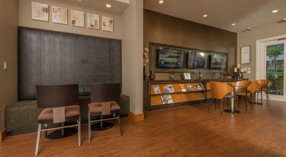 Houston apartment for rent - a living room with a table and chairs and a bar
