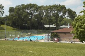 Toronto apartment for rent - a large swimming pool in the middle of a grassy field