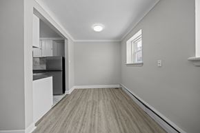 Ottawa apartment for rent - A kitchen with a refrigerator, cabinets, and a window.