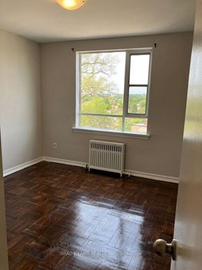 Toronto apartment for rent - an empty room with a window and wooden floors