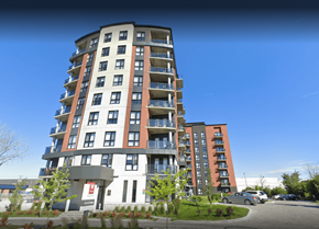 Pointe-Claire apartment for rent - a view of a tall building with a blue sky in the background