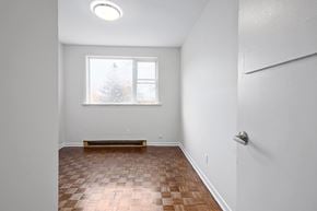 Collingwood apartment for rent - an empty living room with wood flooring and a window