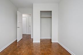 Collingwood apartment for rent - an empty room with white walls and wooden floors and closet doors