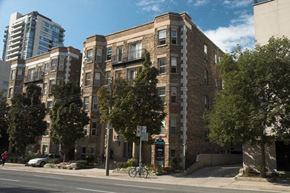 Toronto apartment for rent - a brick apartment building on the corner of a city street