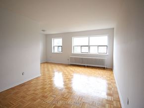 Burlington apartment for rent - an empty living room with a wood floor and a radiator