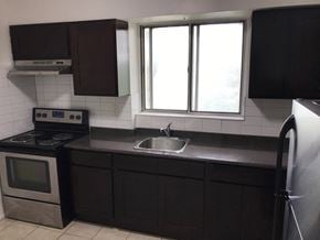 Toronto apartment for rent - an empty kitchen with a sink and a window