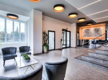 Pointe-Claire apartment for rent - a large living room with chairs and a table