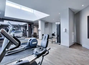 Pointe-Claire apartment for rent - the gym is equipped with cardio equipment and weights