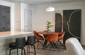 Pointe-Claire apartment for rent - a dining room with a table and chairs and a potted plant