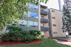 Toronto apartment for rent - an exterior view of a building with grass and trees