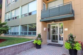 Toronto apartment for rent - the entrance to a building with flowers in front of it