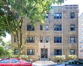 Toronto apartment for rent - the exterior of a brick building with a tree in front of it