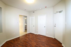 Toronto apartment for rent - an empty living room with wood floors and white walls