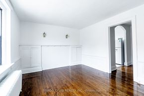 Toronto apartment for rent - a living room with white walls and wood floors