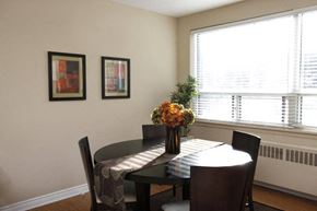 Hamilton apartment for rent - a dining room table with a vase of flowers on it