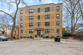 Toronto apartment for rent - a large brick apartment building with a parking lot