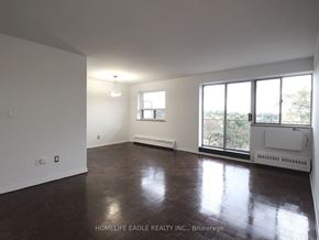 Toronto apartment for rent - an empty living room with wood floors and a large window