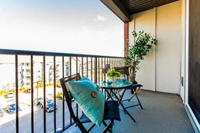 Edmonton apartment for rent - a balcony with a table and chairs and a view of the ocean