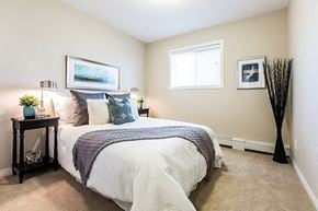Edmonton apartment for rent - a bedroom with a bed and a window
