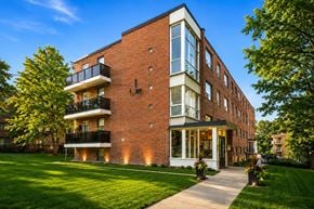 Toronto apartment for rent - A red brick building with a balcony on the second floor.
