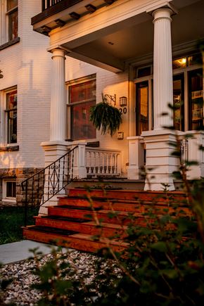 Ottawa apartment for rent - A white house with a red staircase leading to the front door.