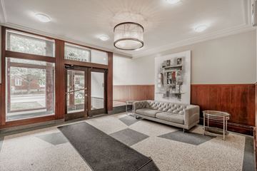 Ottawa apartment for rent - A living room with a white couch and a grey rug.