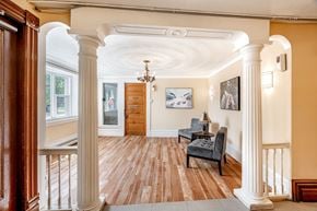 Aylmer apartment for rent - A room with a chandelier, a couch, and a painting on the wall.