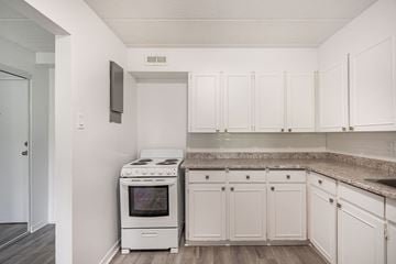 Aylmer apartment for rent - A kitchen with white cabinets and a stove top oven.