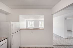 Aylmer apartment for rent - A kitchen with a refrigerator and a window.