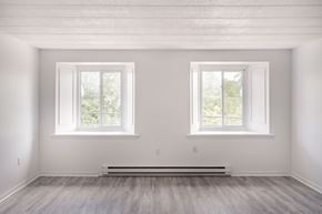 Aylmer apartment for rent - A room with two windows and a radiator on the floor.