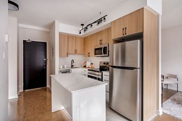 Ottawa apartment for rent - A modern kitchen with wooden cabinets and stainless steel appliances.