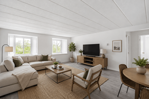 Aylmer apartment for rent - A living room with a white couch, a wooden coffee table, and a television.