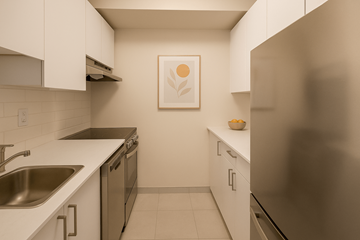 Ottawa apartment for rent - A kitchen with a refrigerator, sink, and cabinets.