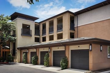 San Diego apartment for rent - A building with a balcony and a garage door.