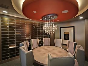 San Diego apartment for rent - A modern dining room with a round table and grey chairs at West Park Apartments, San Diego, California