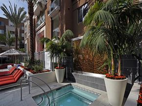 San Diego apartment for rent - A pool surrounded by plants and a red bench at West Park Apartments, California